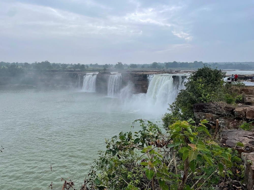 Chitrakoot Waterfall cascading in golden light near Dandami Luxury Resort